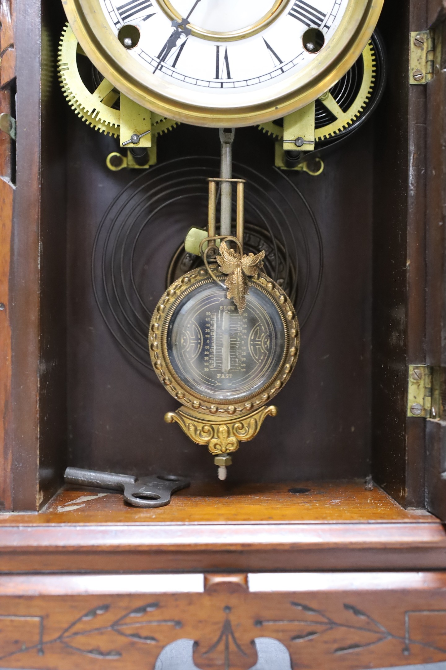 An architectural carved walnut mantel clock - 52cm tall